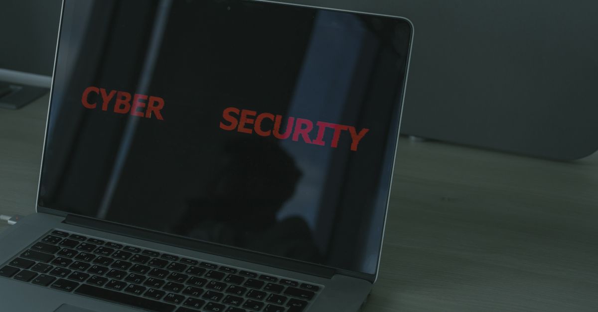 A laptop screen displaying cybersecurity code — the threats a HIPAA risk assessment is designed to surface.
