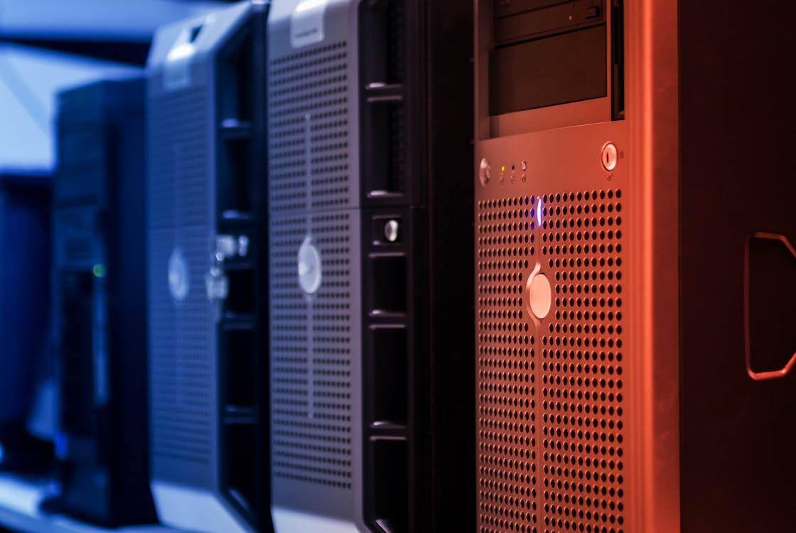 Server towers with contrasting blue and orange lighting — representing the choice between ISO 27001 and SOC 2.