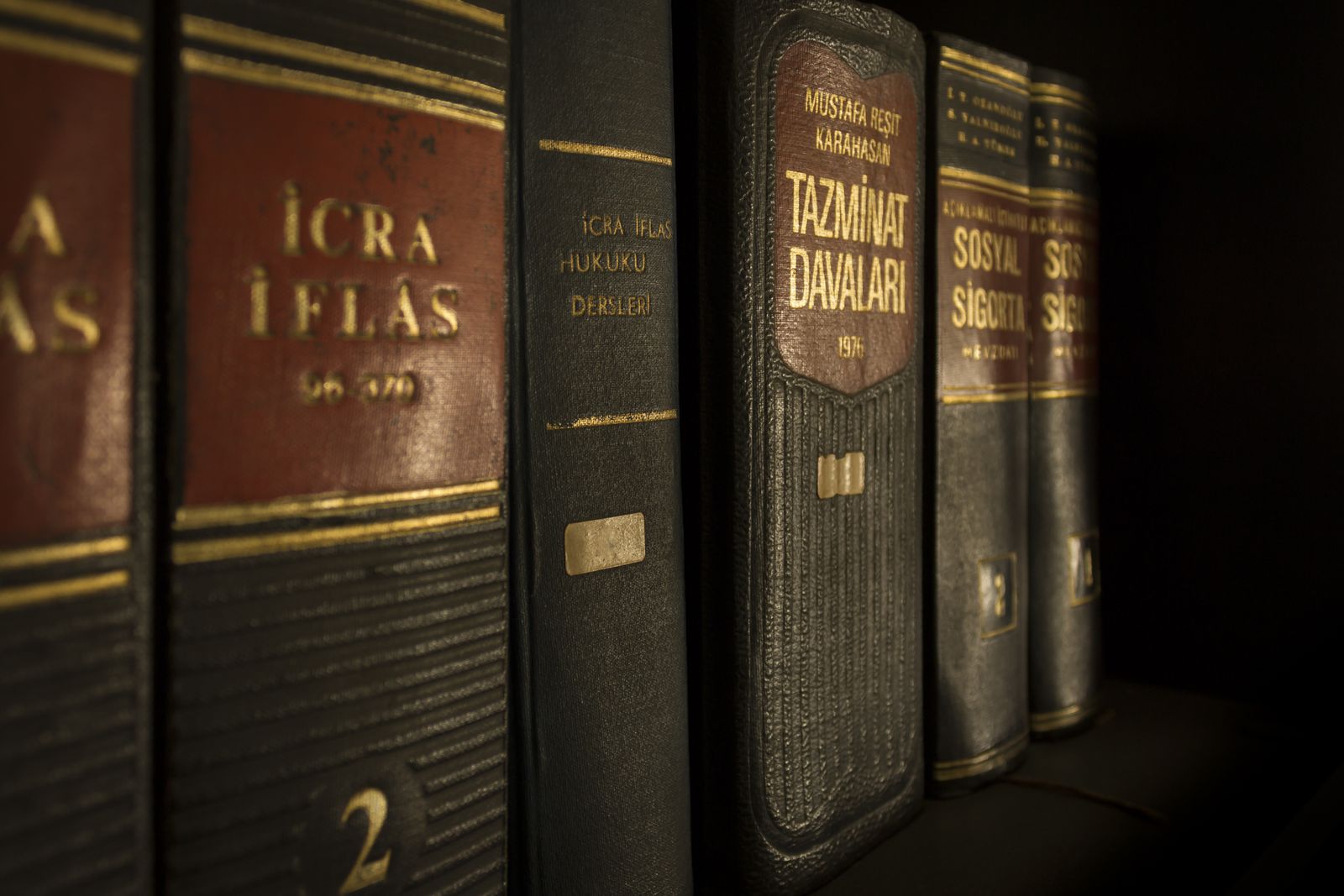 A close-up of bound law and regulation volumes on a bookshelf.